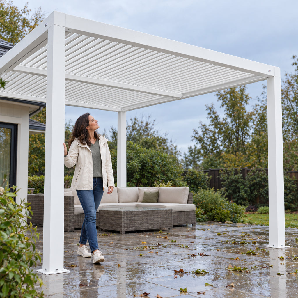 Louvered Pergola Modern White Pergola, woman stepping out onto the patio and placing a hand on the frame