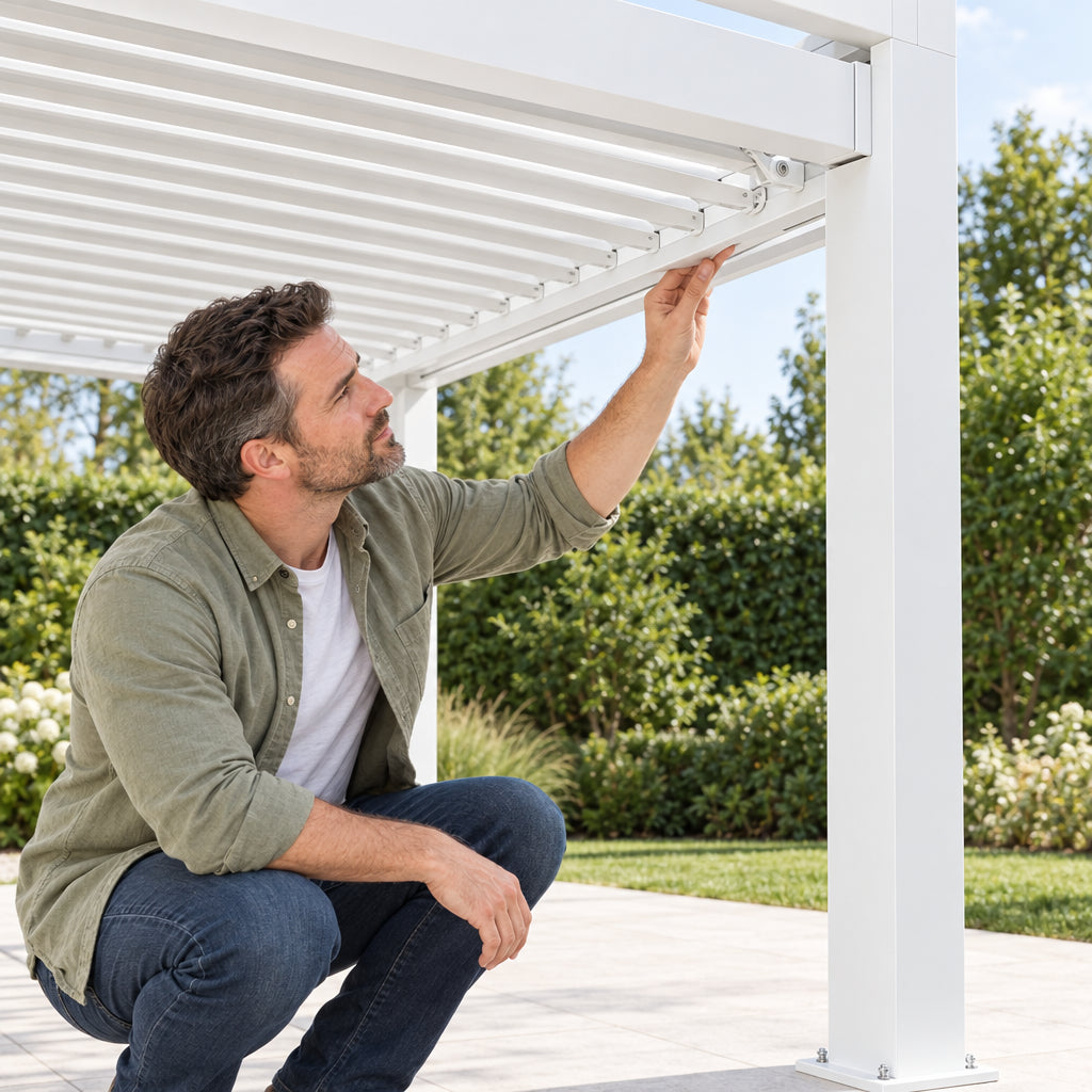 Louvered Pergola Modern White Pergola, man crouching beside one of the posts and running a hand along a louver blade